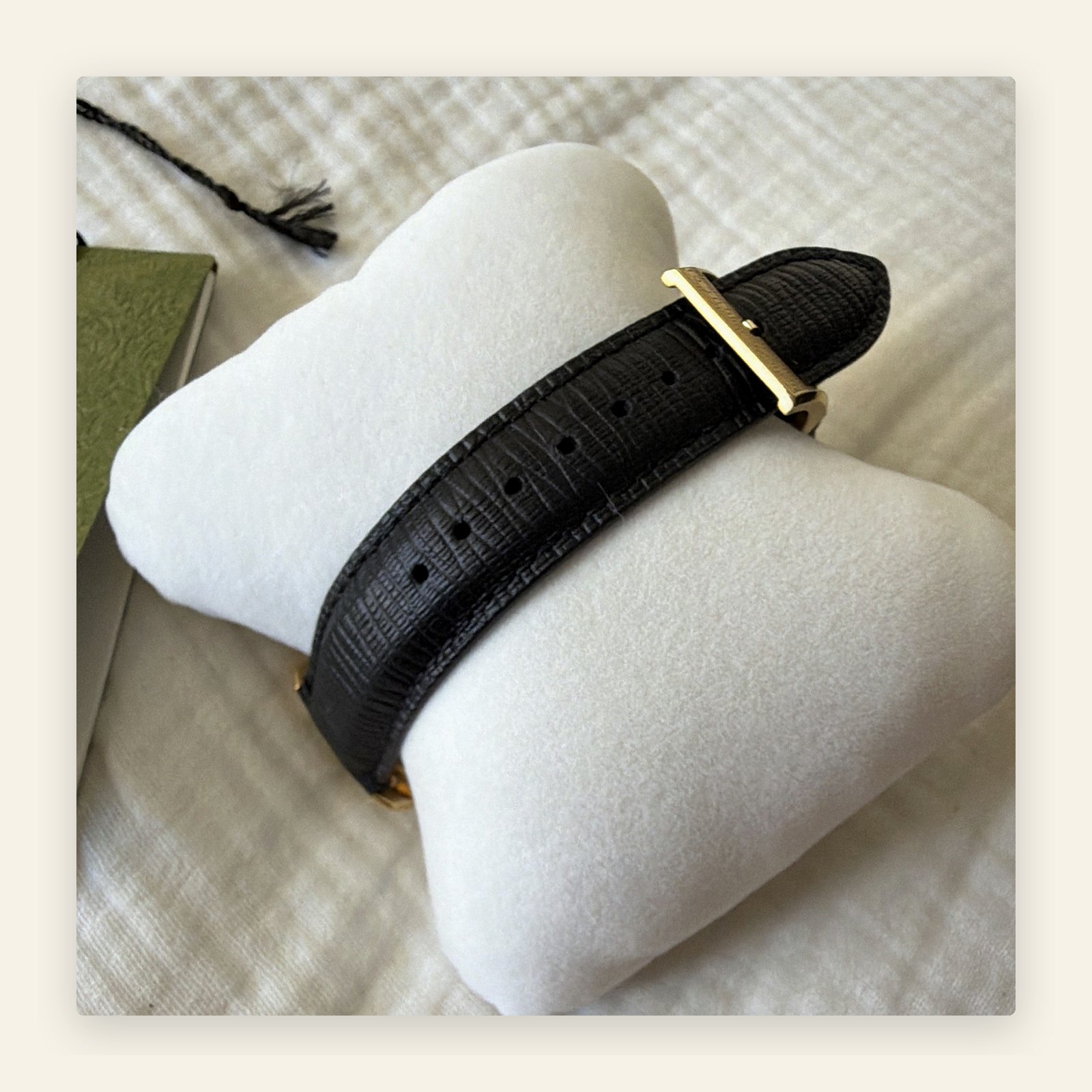 Gucci automatic watch with gold dial and black leather strap